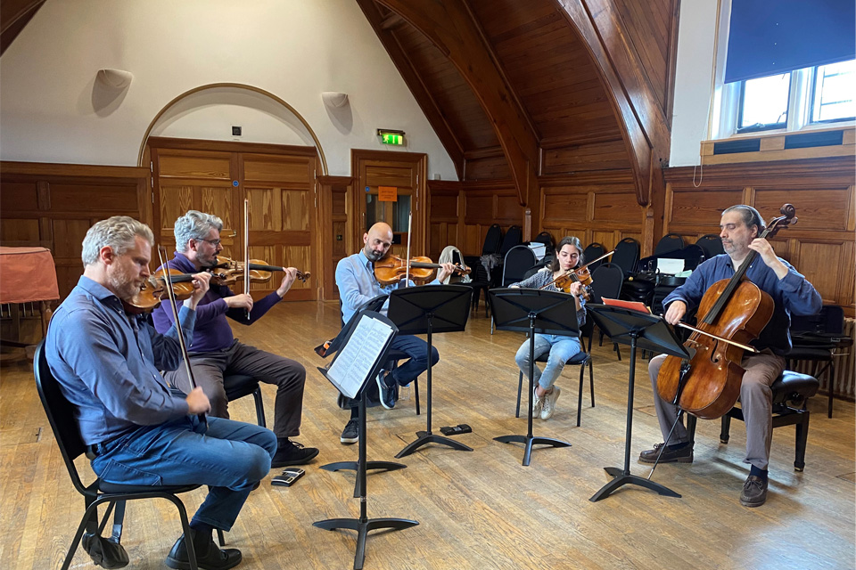Five string players rehearsing 鶹Ƶ 